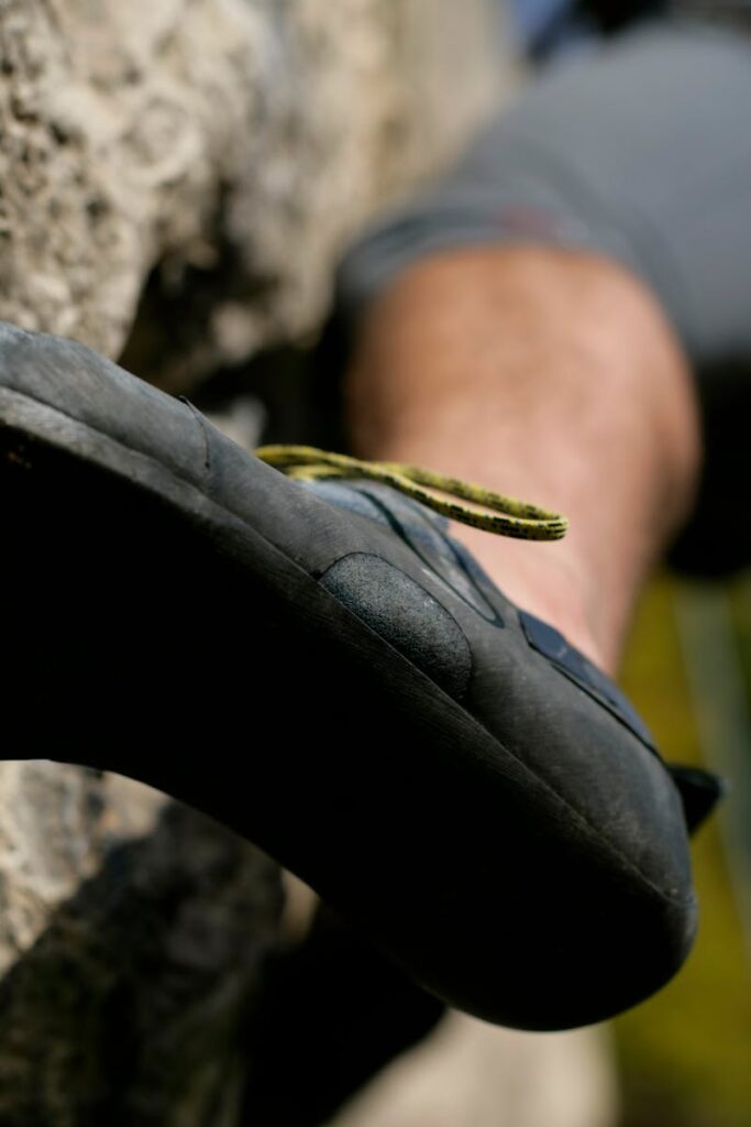 pexels-photo-12659349-12659349 Dynamic image of a climber's shoe gripping a rock face, emphasizing sport and adventure.